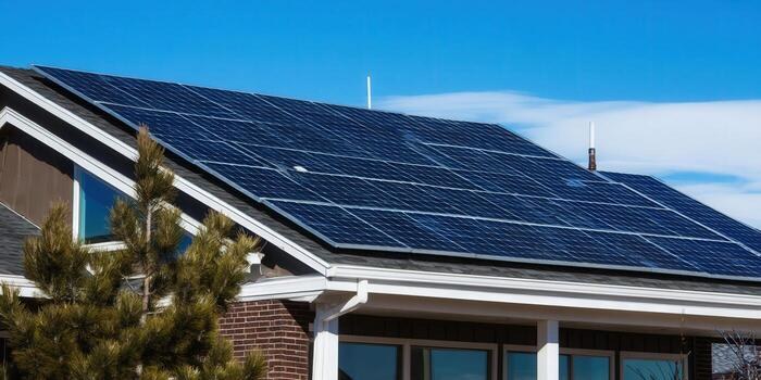 Solar panels on a residential roof under blue sky