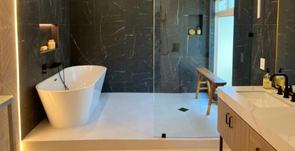 Luxurious remodeled bathroom with freestanding tub and glass shower