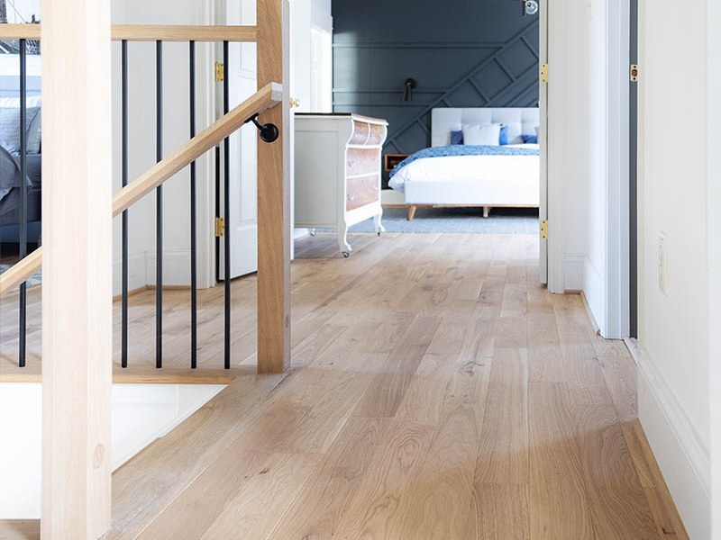 Warm wide-plank hardwood flooring in a renovated home